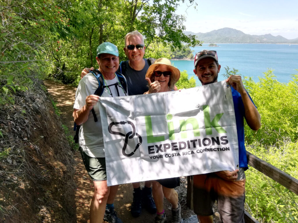 Hiking with ocean views Hikers with the Link Expeditions Flag