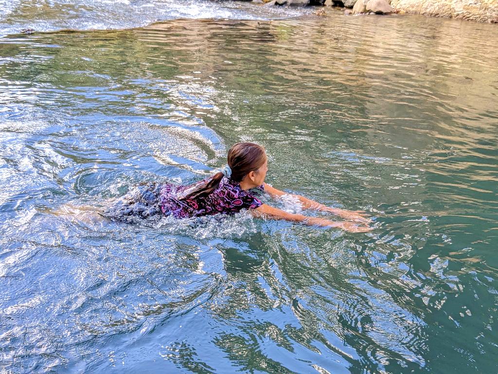 A woman swimming in the refreshing waters of the Aranjuez River, located in La Unión, Puntarenas, Costa Rica