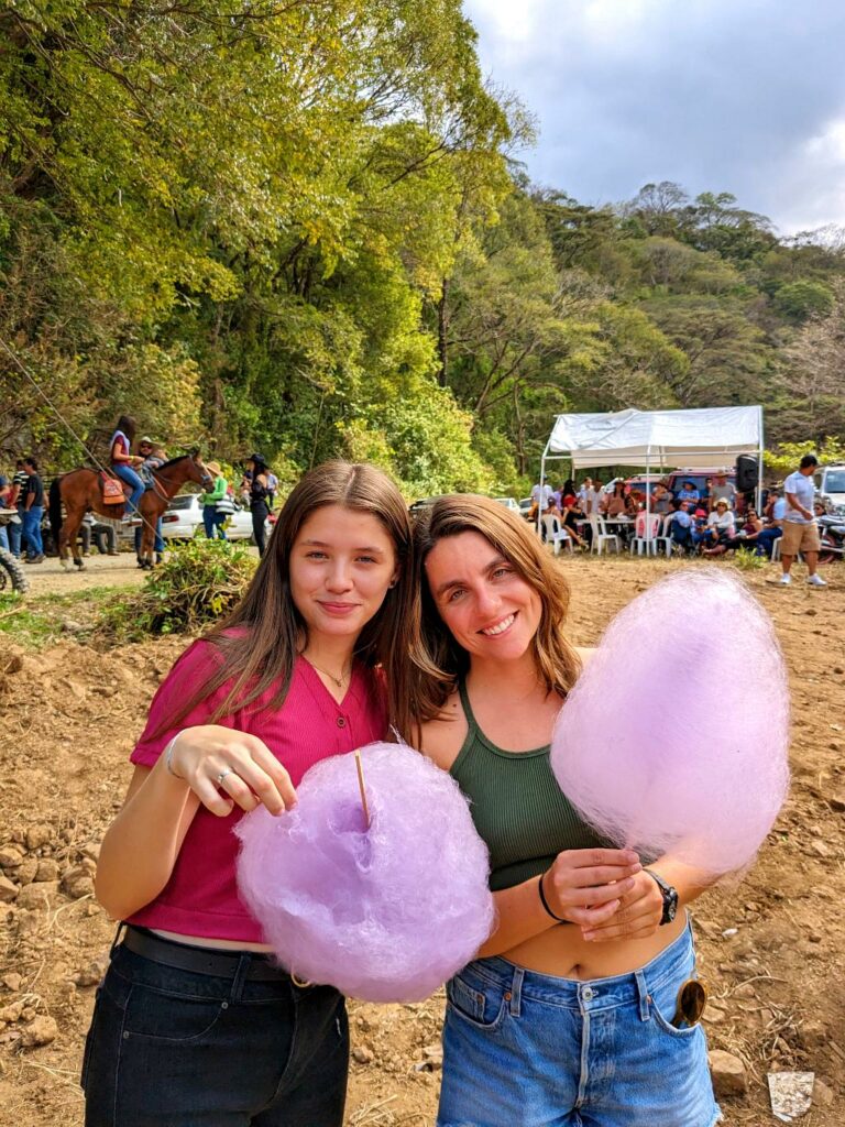A vibrant scene at a traditional party in rural Bajo Caliente, featuring the popular local treat, sugar cotton