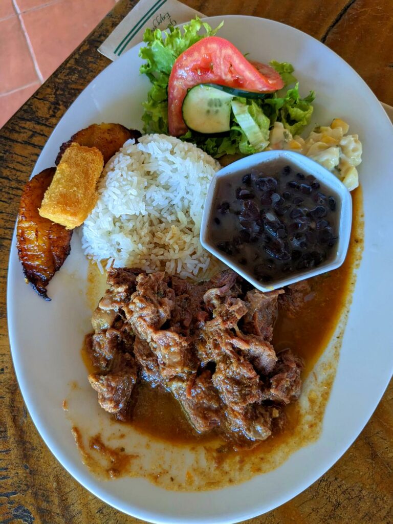 A traditional Casado lunch served in La Unión, featuring rice, beans, salad, plantains, and a choice of meat