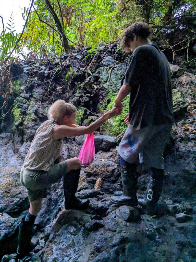 A student holding the hand of Ms. Nancy, founder of the Biological Station near Corcovado National Park