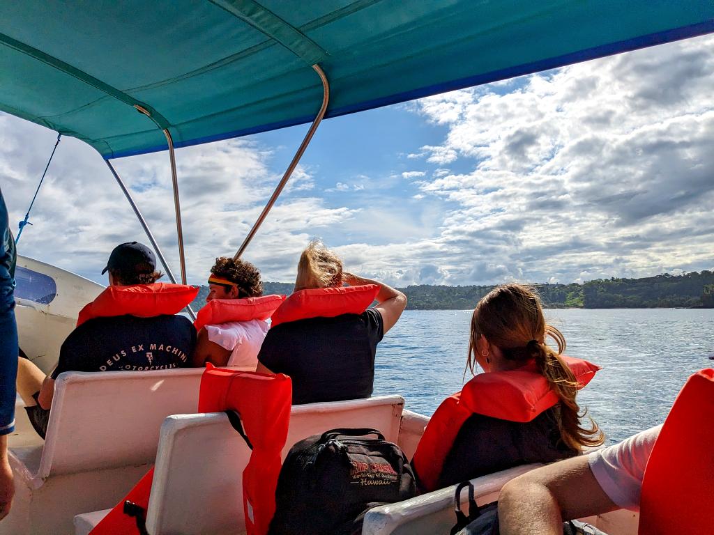 A traveler wearing a life jacket in a boat on the way from Corcovado to Sierpe