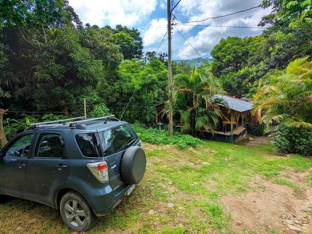 Car parked in the designated parking area with Boquerones Hike's reception in view, Bajo Caliente.