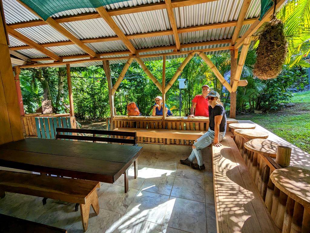 Dining tables and benches at Boquerones Hike reception in Bajo Caliente, Costa Rica.