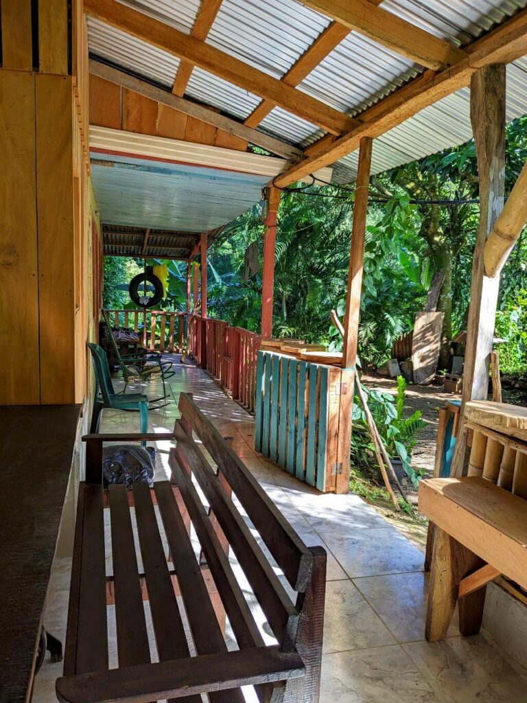 Reception area with benches and rocking chairs at Boquerones Hike in Bajo Caliente, Puntarenas.