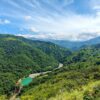 Panoramic view of the Aranjuez River converging with the El Encanto Hydroelectric Dam, nestled amidst verdant mountains.