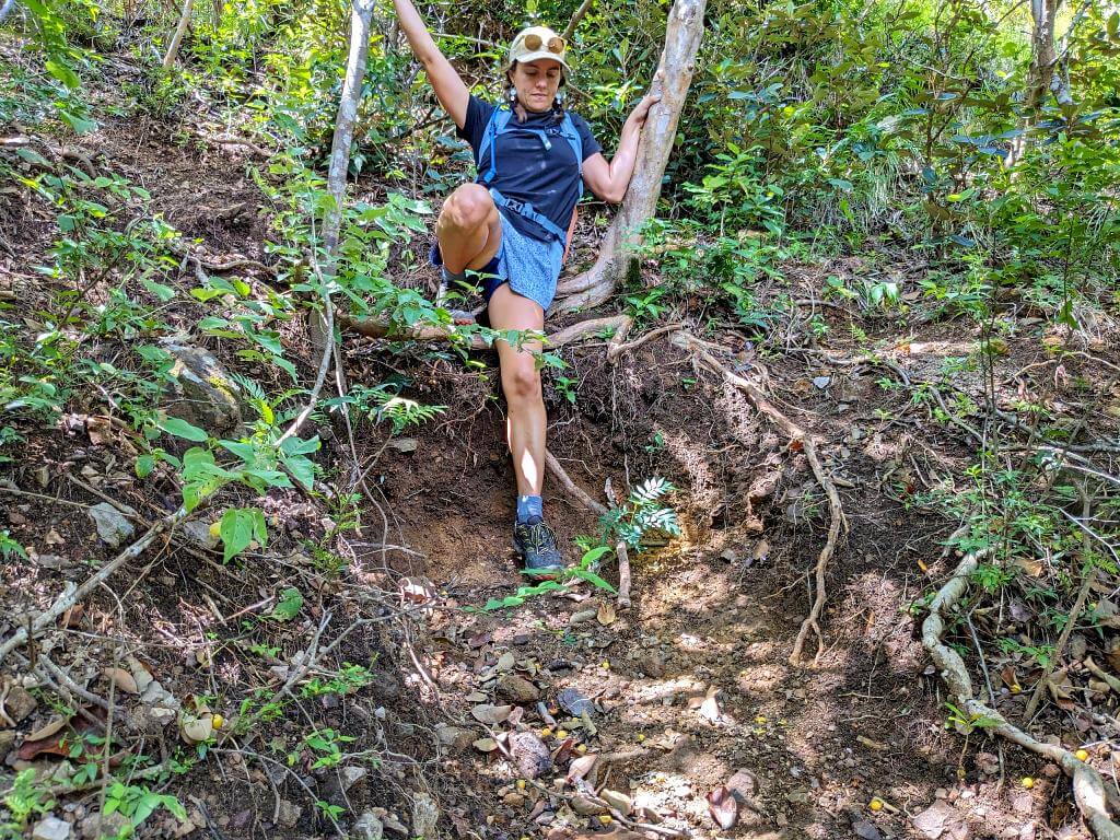 Hiker navigating a challenging descent on the El Encanto trail towards the Aranjuez River.