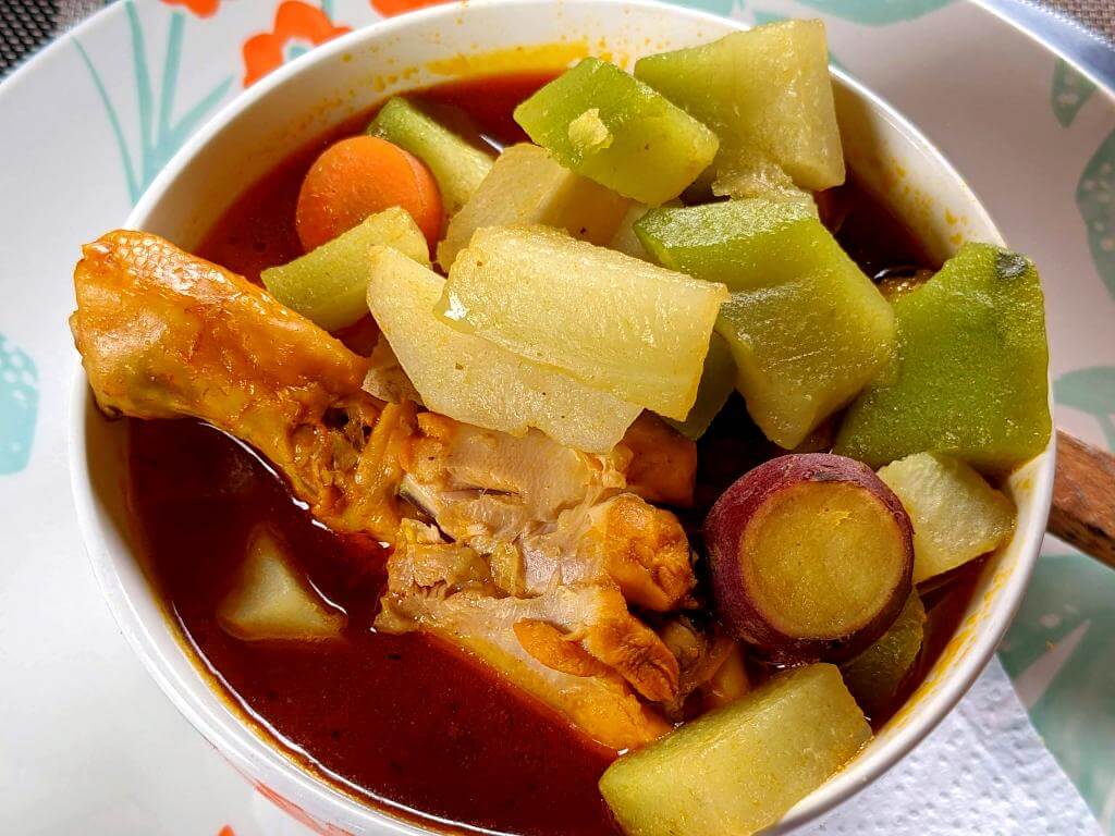 Warm chicken and veggie soup served on a plate, ideal for a chilly day in San Gerardo de Dota.