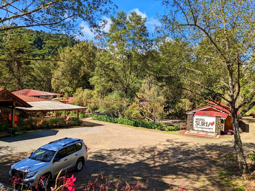 View of the restaurant, reception, and parking lot of Hotel Suria, situated at the end of the road in San Gerardo de Dota Valley, Costa Rica.