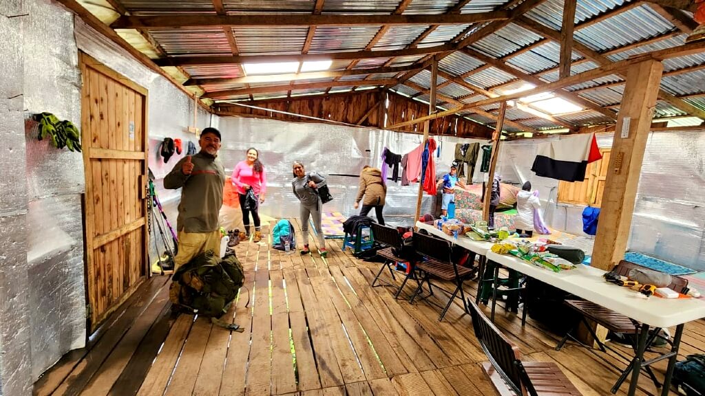 View of the Albergue, a refuge for rest and preparation before the early morning hike to the summit of Cerro Ena. The image showcases the simple and basic construction of the shelter, offering a glimpse into the accommodation for a night's rest.