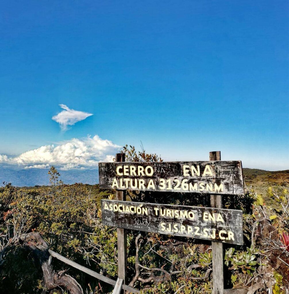 Signpost of "Asociación Turismo Ena" (ATURENA) indicating "Cerro Ena" at an altitude of 3126 meters (10255.91 feet) above sea level.
