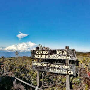 Signpost of "Asociación Turismo Ena" (ATURENA) indicating "Cerro Ena" at an altitude of 3126 meters (10255.91 feet) above sea level.