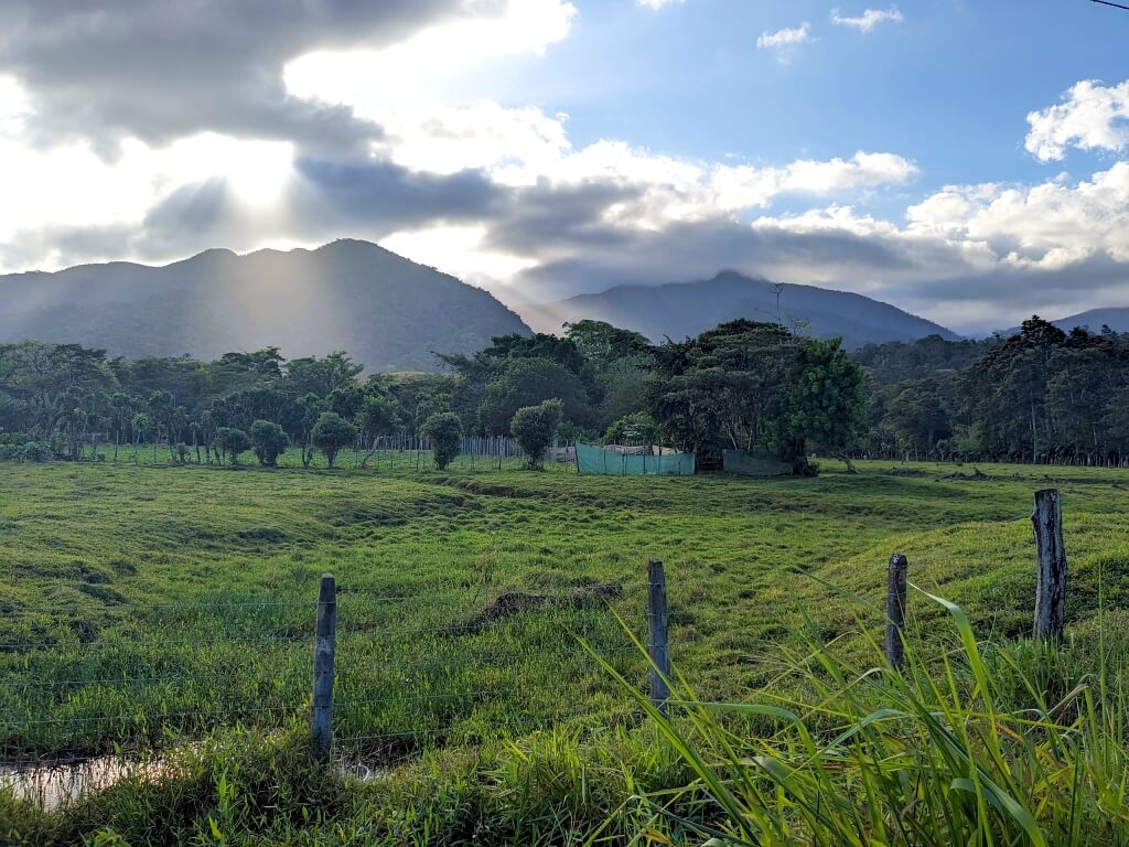 Sunrays illuminating pastures in rural Bijagua