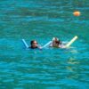 Mother and child floating peacefully in the sea, a moment of peace and fun.