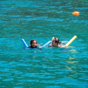 Mother and child floating peacefully in the sea, a moment of peace and fun.