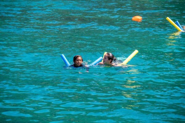 Mother and child floating peacefully in the sea, a moment of peace and fun.