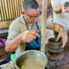 Craftsman demonstrating the pottery-making process using traditional Guaitil techniques at Buena Vista del Rincón.