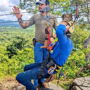 Professional staff giving safety instructions before the canopy tour, with clients equipped and ready to go.