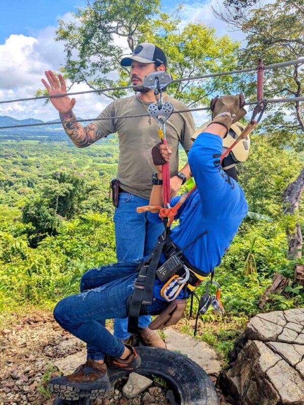Professional staff giving safety instructions before the canopy tour, with clients equipped and ready to go.