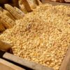 Rustic wooden box filled with corn kernels and ears of corn