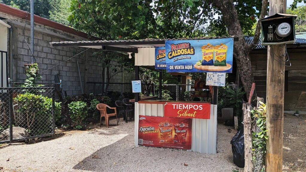 Local caldosa stand in Potrero, Guanacaste, Costa Rica, serving fresh ceviche and chips — a popular sunny-day snack