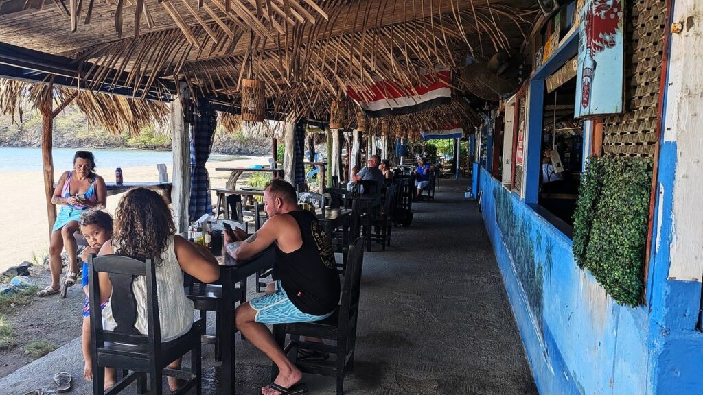 Guests dining at oceanfront tables at Las Brisas Restaurant in Potrero, Guanacaste, Costa Rica, known for fresh local seafood